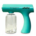 Turquoise nano spray machine with clear container on a white surface