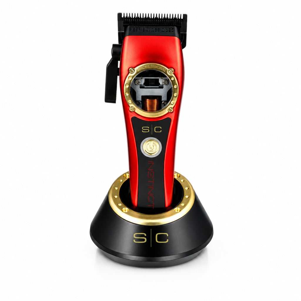 StyleCraft Instinct SC607M cordless hair clipper in red on charging stand