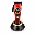 StyleCraft Instinct SC607M cordless hair clipper in red on charging stand